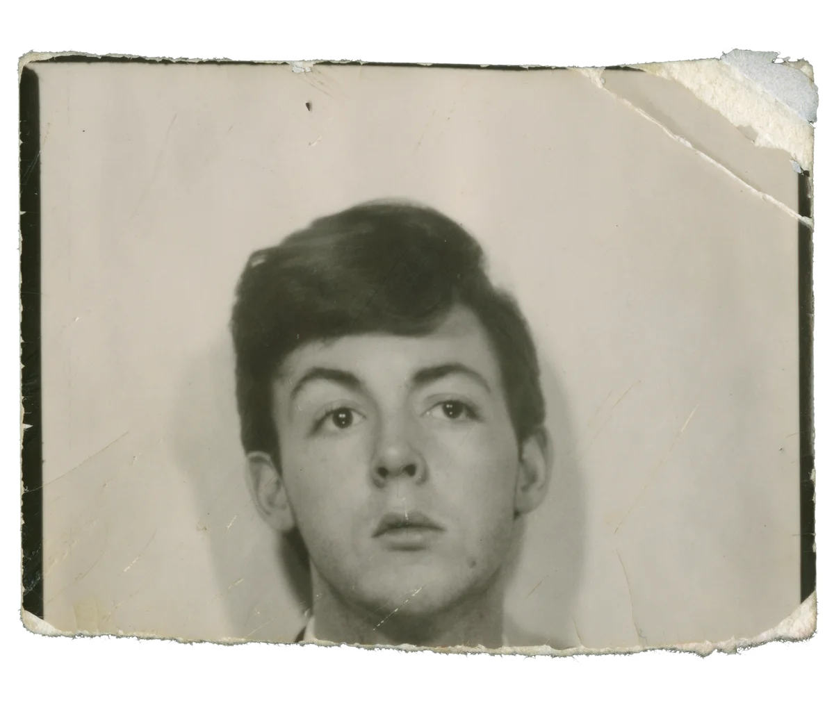 Original photo-booth portrait of a teenage Paul McCartney, worn black and white print